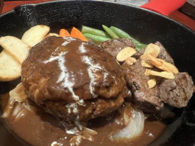 鉄板にハンバーグとステーキの料理